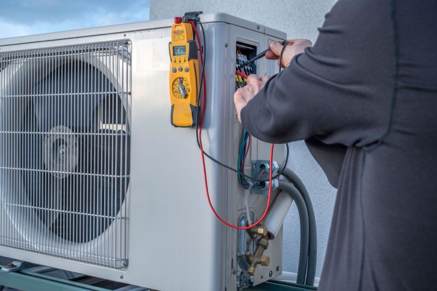 Comfort Central technician servicing an HVAC unit