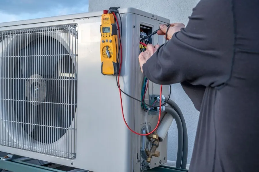Comfort Central technician servicing an HVAC unit